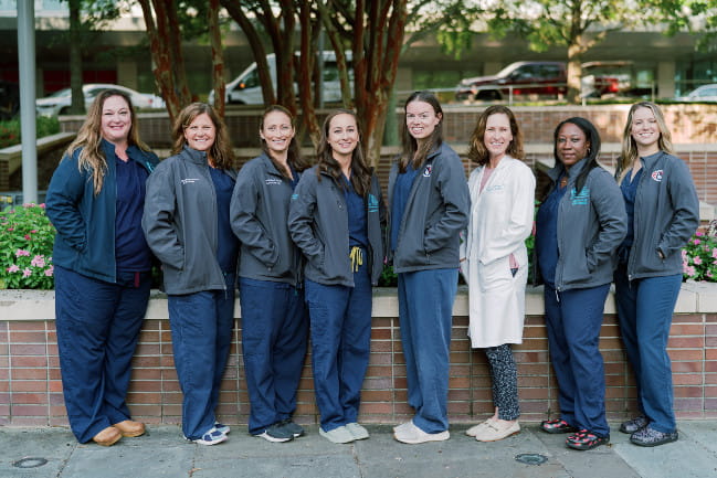 Eight MUSC Health care team members standing in a line smiling
