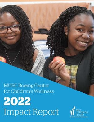 Cover image of two children smiling for the Boeing 2022 Impact Report.