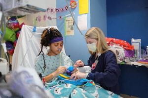 Carte team member with patient in hospital room.