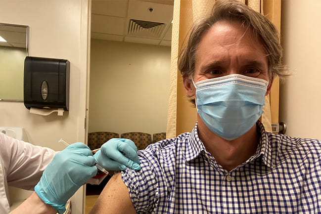 Dr. Mark Scheurer, chief for Children’s and Women’s Services at the Medical University of South Carolina, gets his first dose of the COVID-19 vaccine.