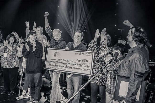Blue Dogs fundraising concert check presentation