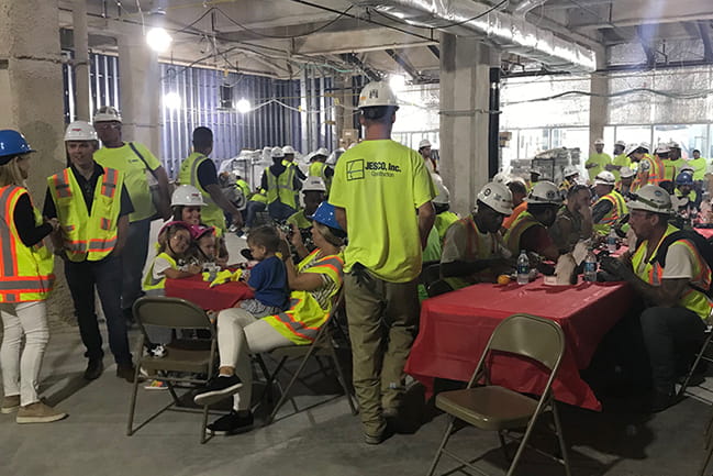 The construction crew enjoys breakfast delivered by Shawn Jenkins and his family
