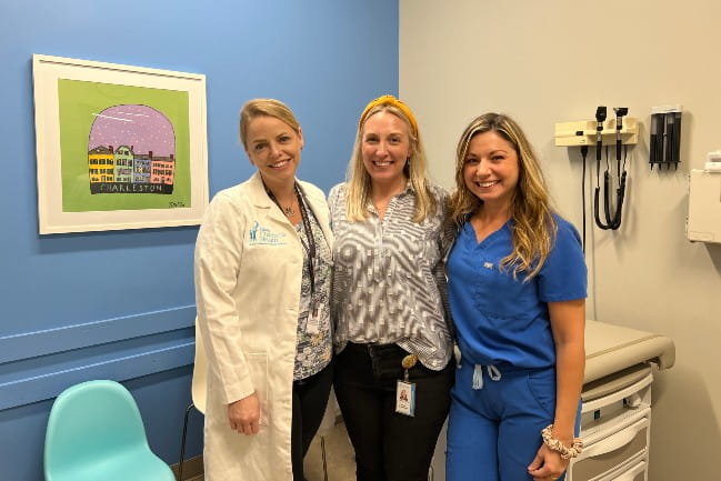 Three smiling pediatric urilogy care team members.