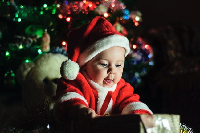A baby dressed as Santa.