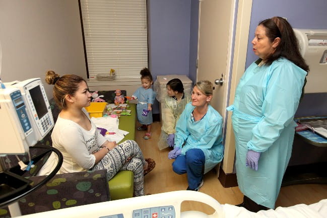 Image of patient, care giver, and translator working together. 