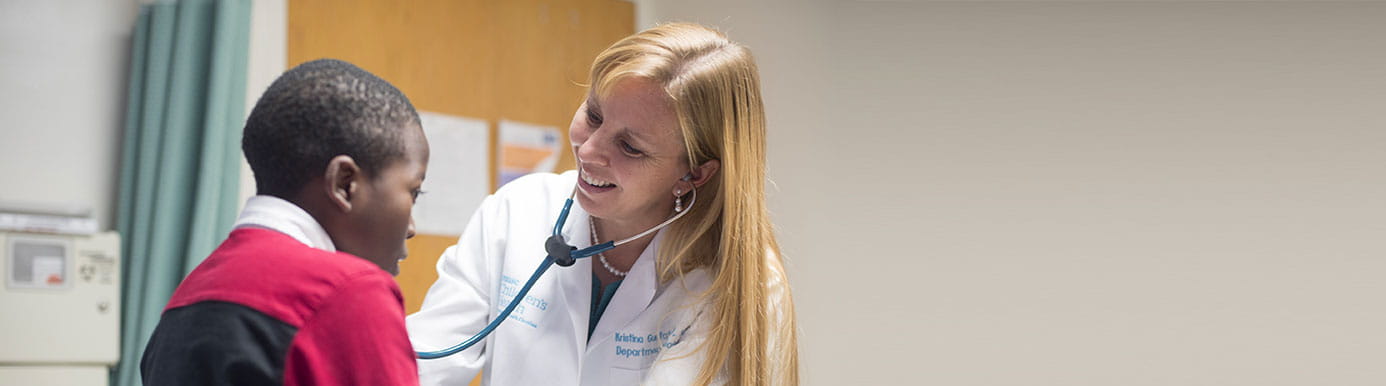 Dr. Kristina Gustafson with young patient