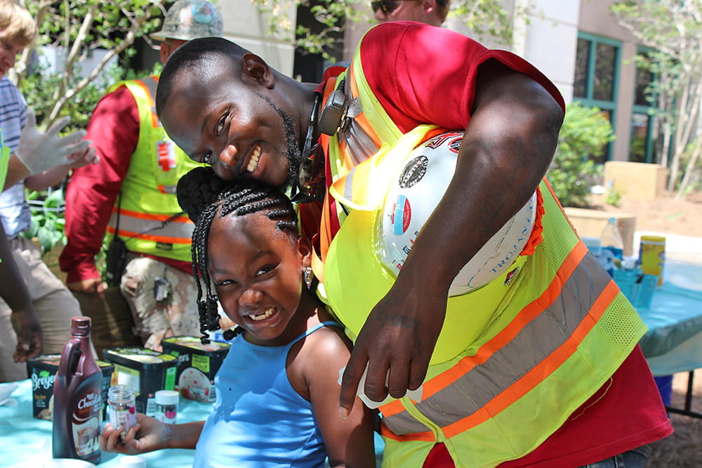 A construction worker and his daughter smile for the camera