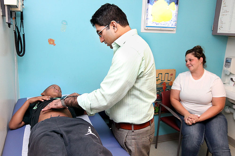 Dr. Satish Nadig checks Gabe Cade's liver