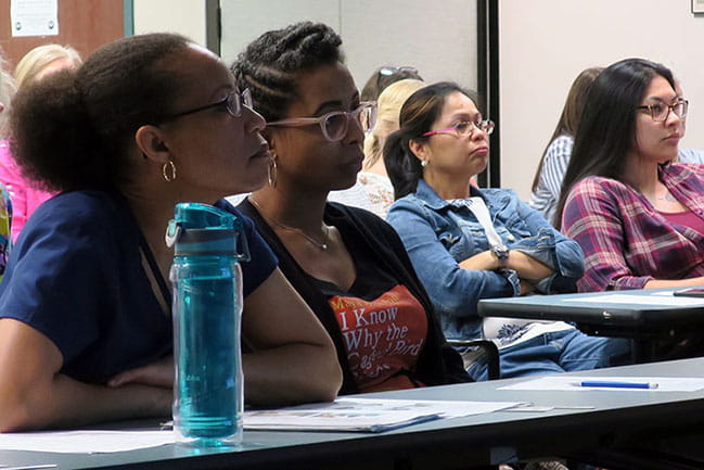 School nurses, including Shernette Tolley, left, listen to a discussion about bleeding control.