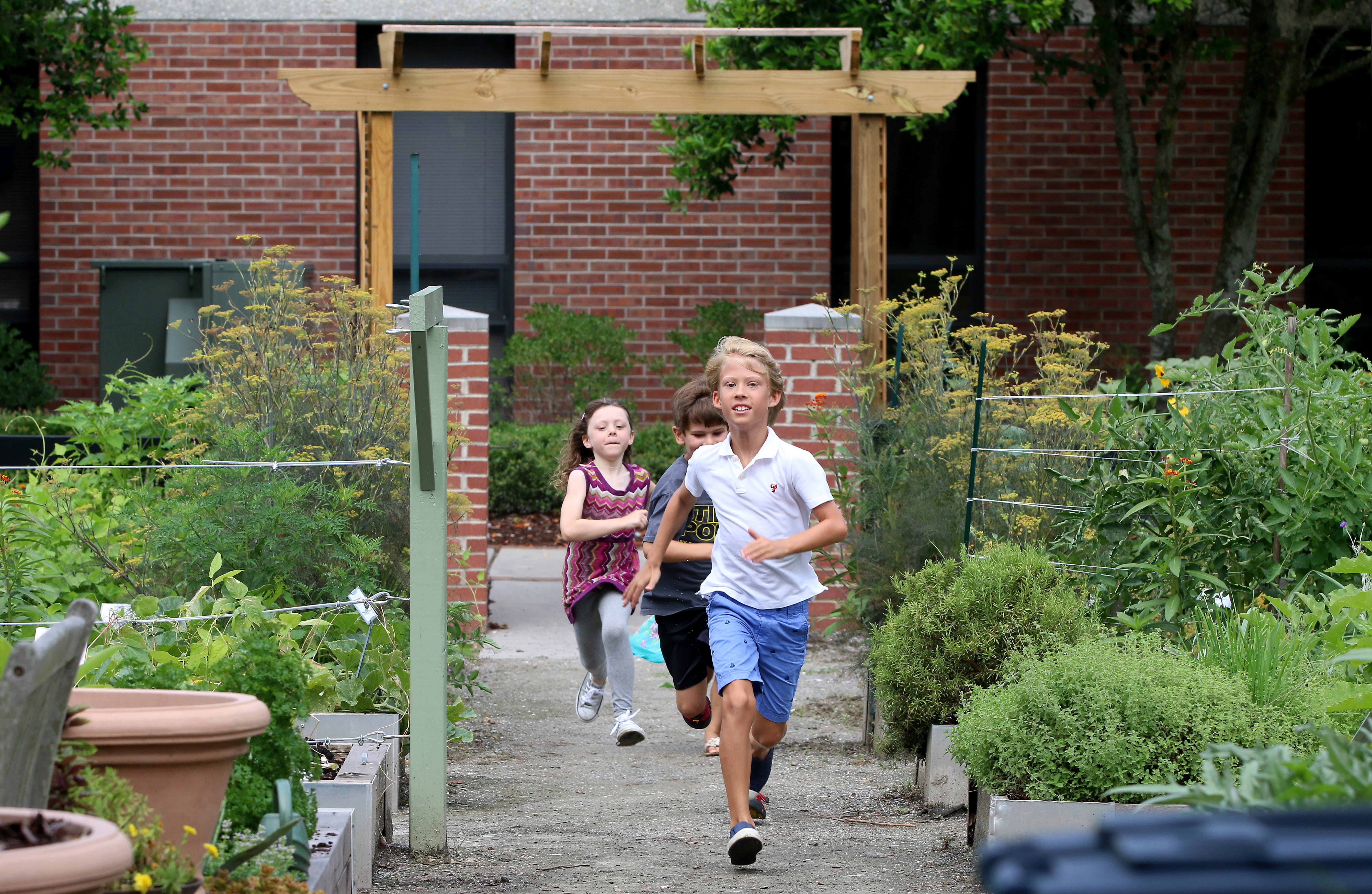 Children at school running down a garden path, courtesy of Boeing Center for Children's Wellness