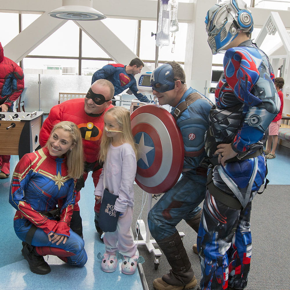 Group of superheroes with girl