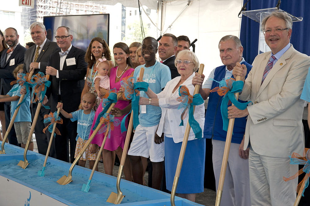 Frank and Pearl Tourville stand holding shovels with other people, including MUSC President David Cole and Charleston Mayor John Tecklenburg, at a groundbreaking ceremony for the MUSC Shawn Jenkins Children's Hospital and Pearl Tourville Women's Pavilion.