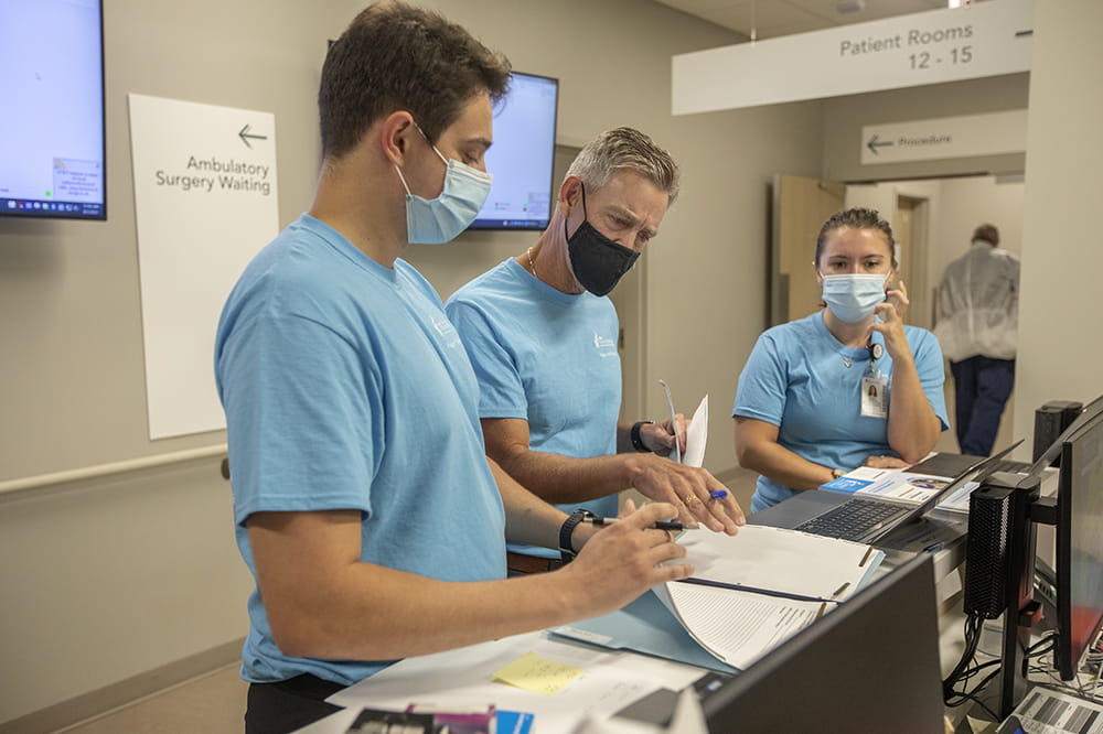 Left to right: Kreighton Milks, program coordinator, talks with Andrew Atz, M.D., chairman of pediatrics at MUSC and Megan Bickford, program manager, about the upcoming patients in the Moderna pediatric dosing clinical trial.