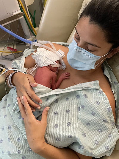 Ally Hampton holds one of her quadruplets.