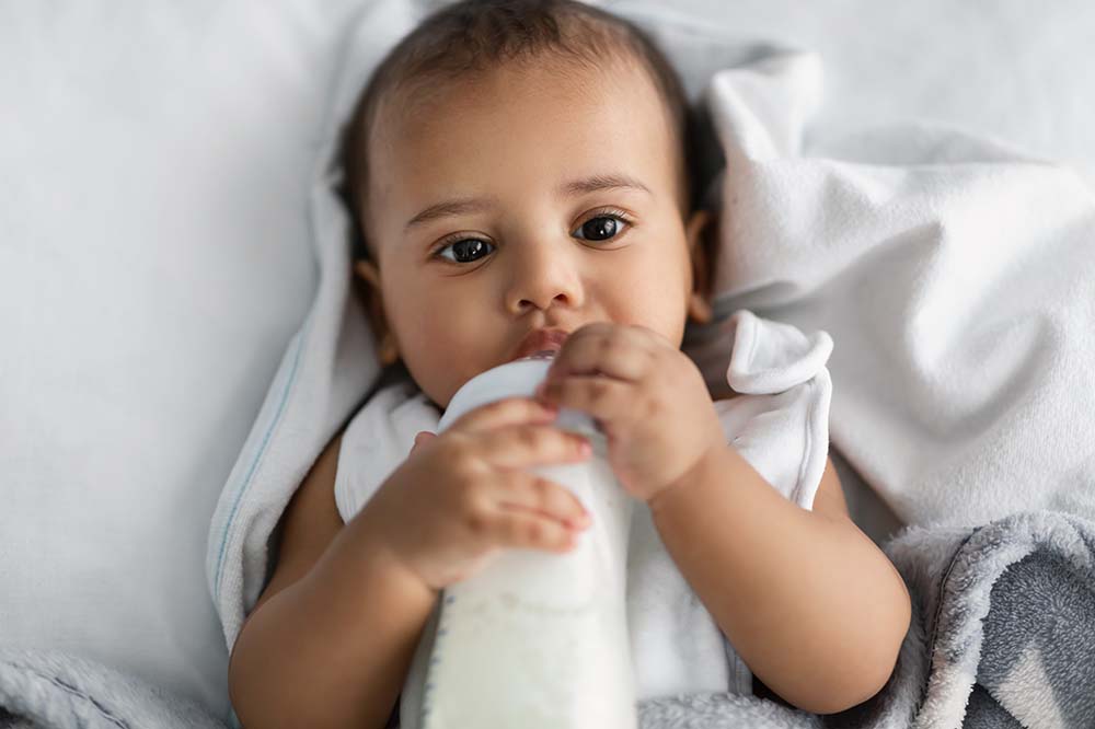 Baby drinking from a bottle. 