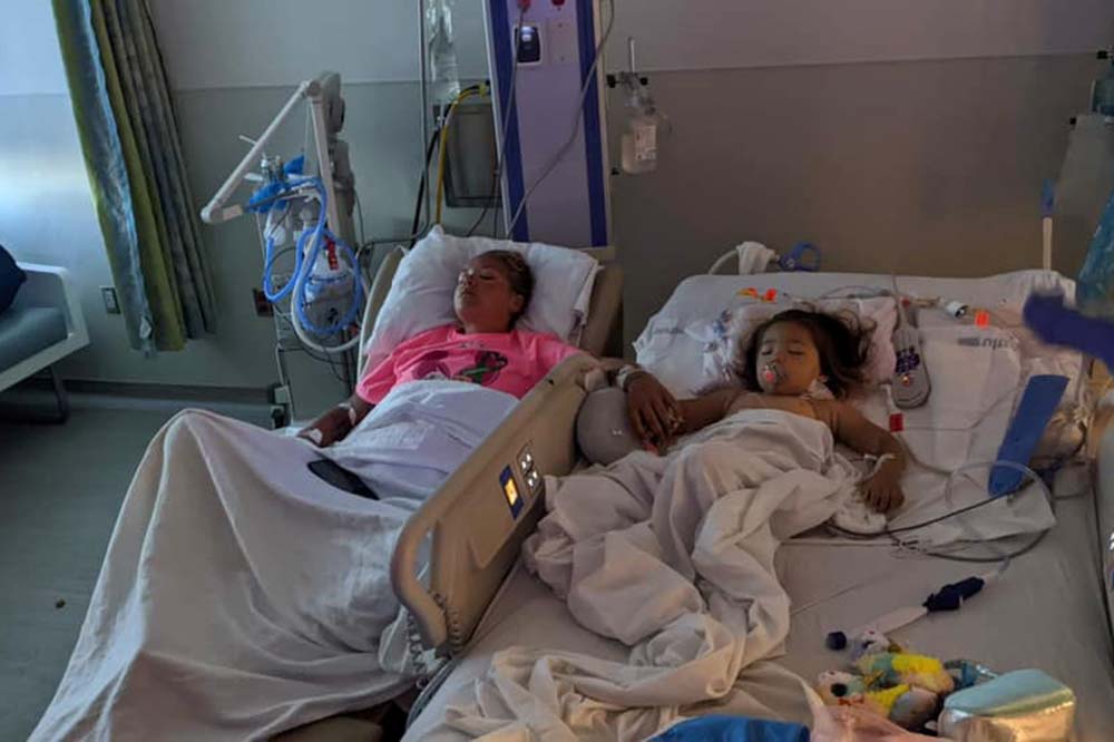 Darkened hospital room with Sara Cathey and her niece Natalyn Mann sleeping after one of Cathey's kidneys was transplanted into the little girl.