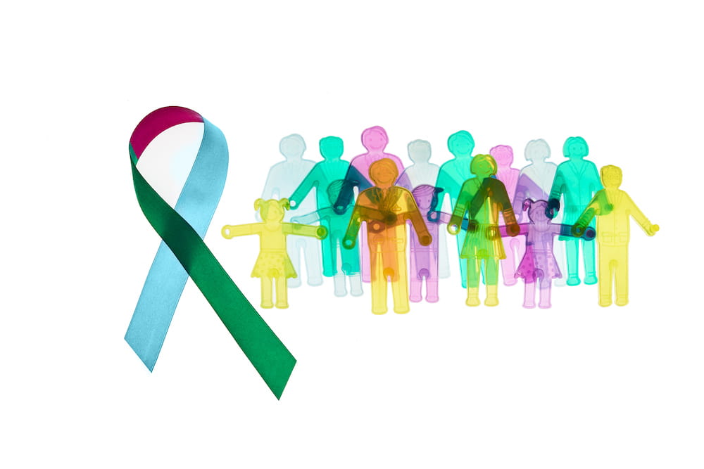 Illustration of a ribbon and group of people pictured in colors associated with Rare Disease Day. Licensed from istockphoto.com