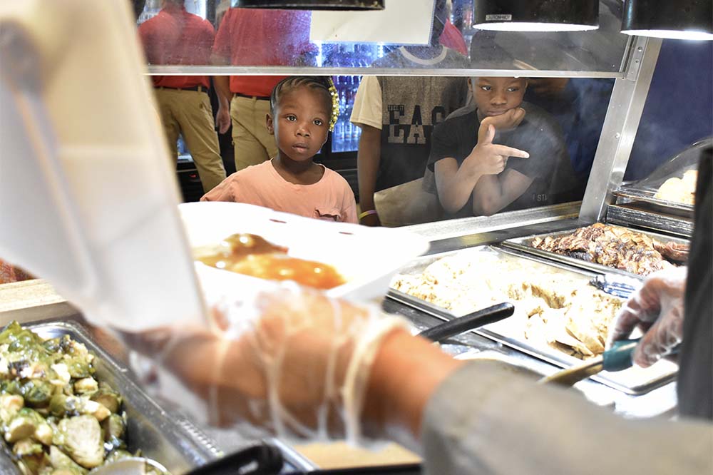 Aamyri Blackwell, left, and Princeton Timmons look at the lunch options during the Kids Eat Free program at MUSC Health Marion Medical Center. Photo by John Russell